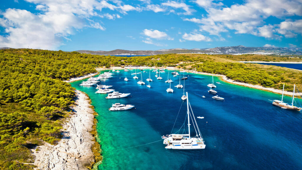 Aerial view of a bay in the Pakleni Islands near Hvar, with yachts and catamarans at anchor